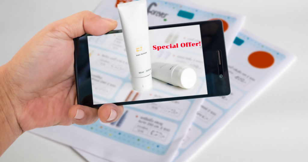 Augmented reality marketing concept. Hand holding smart phone to use A/R application to product detials for A/R catalog.